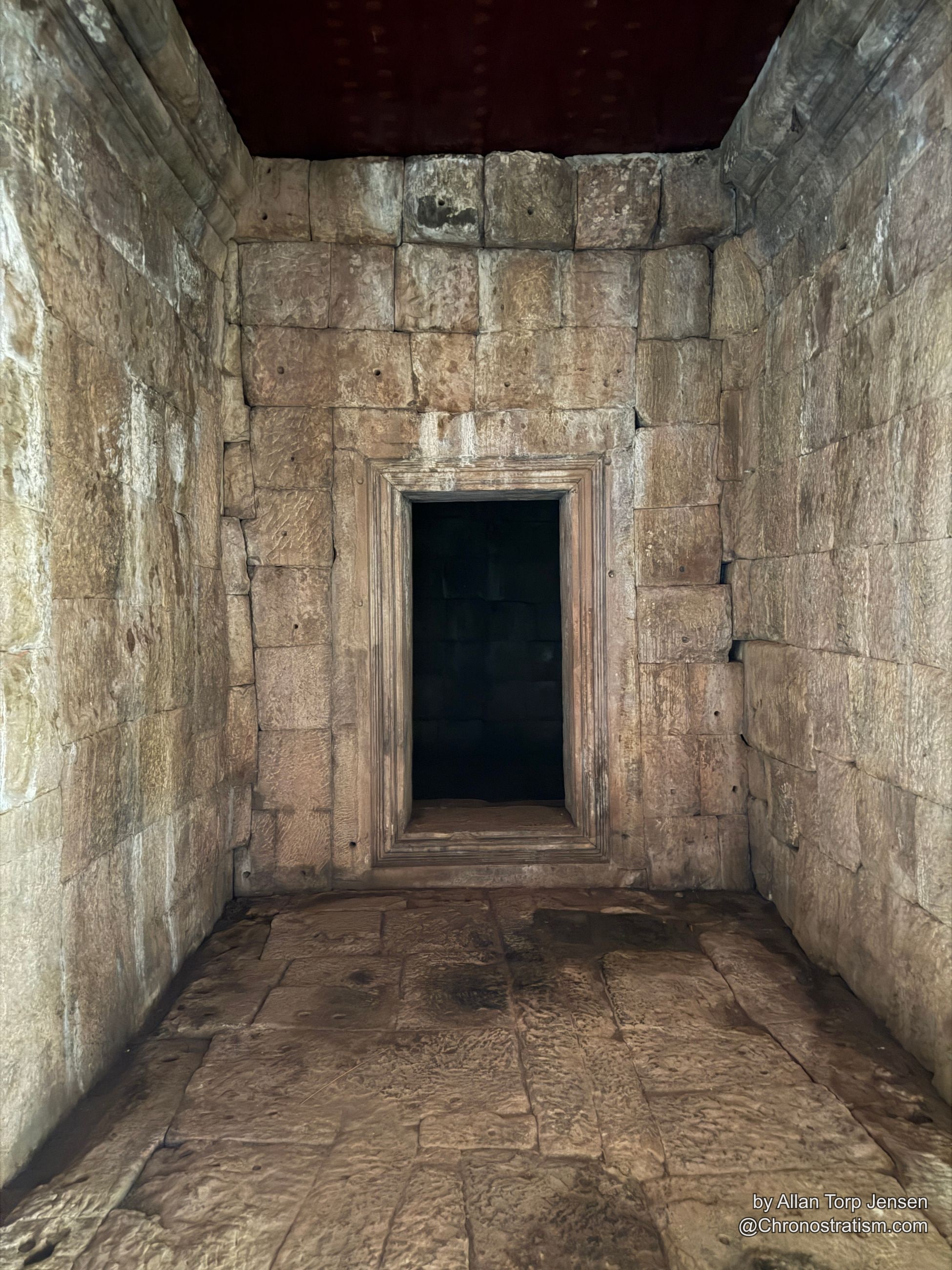 A broom rests in the corner of the same weathered stone chamber.