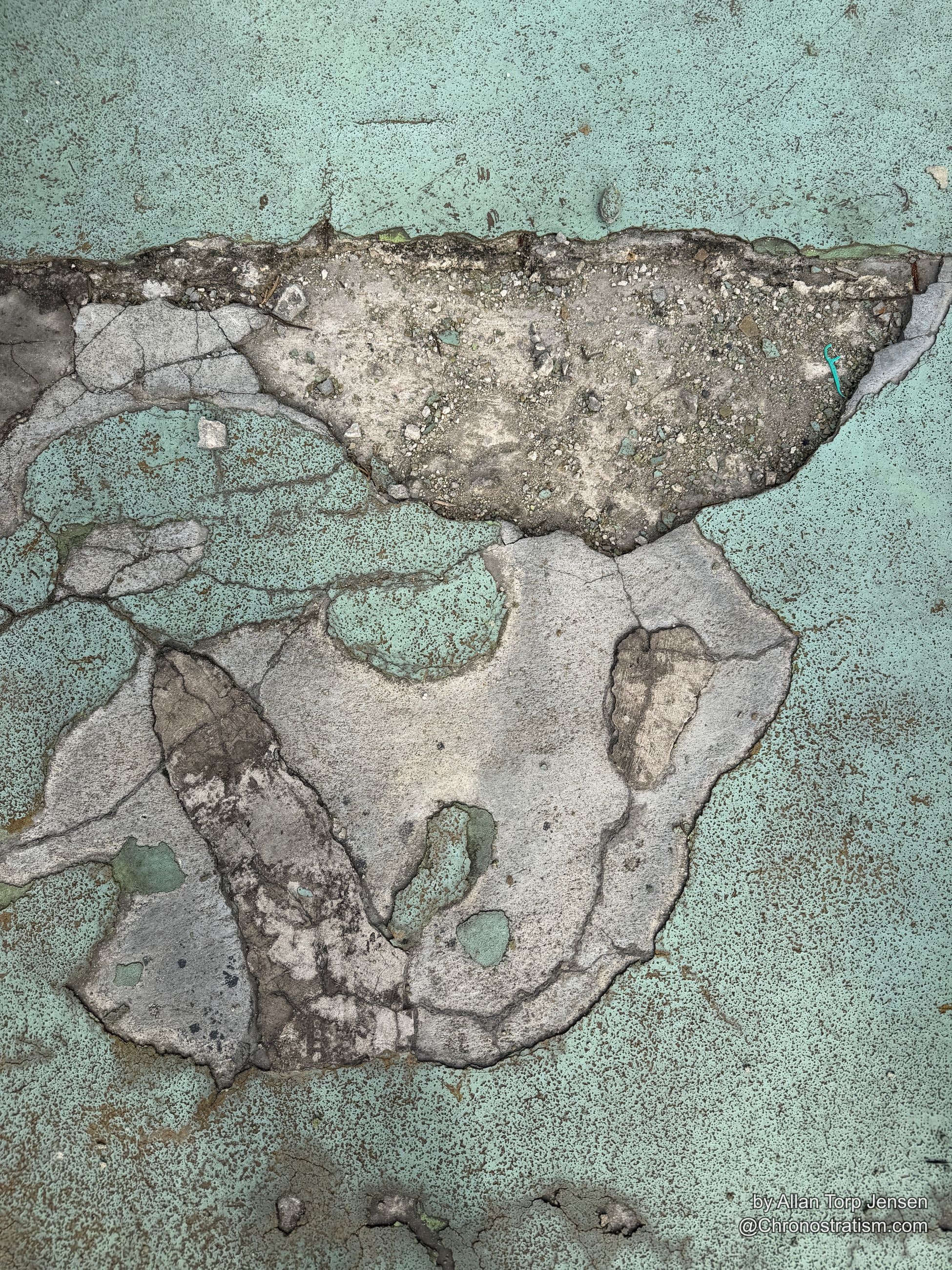 Deep alligator cracking splits mint-green paint, exposed aggregate breaking through the spalling concrete.