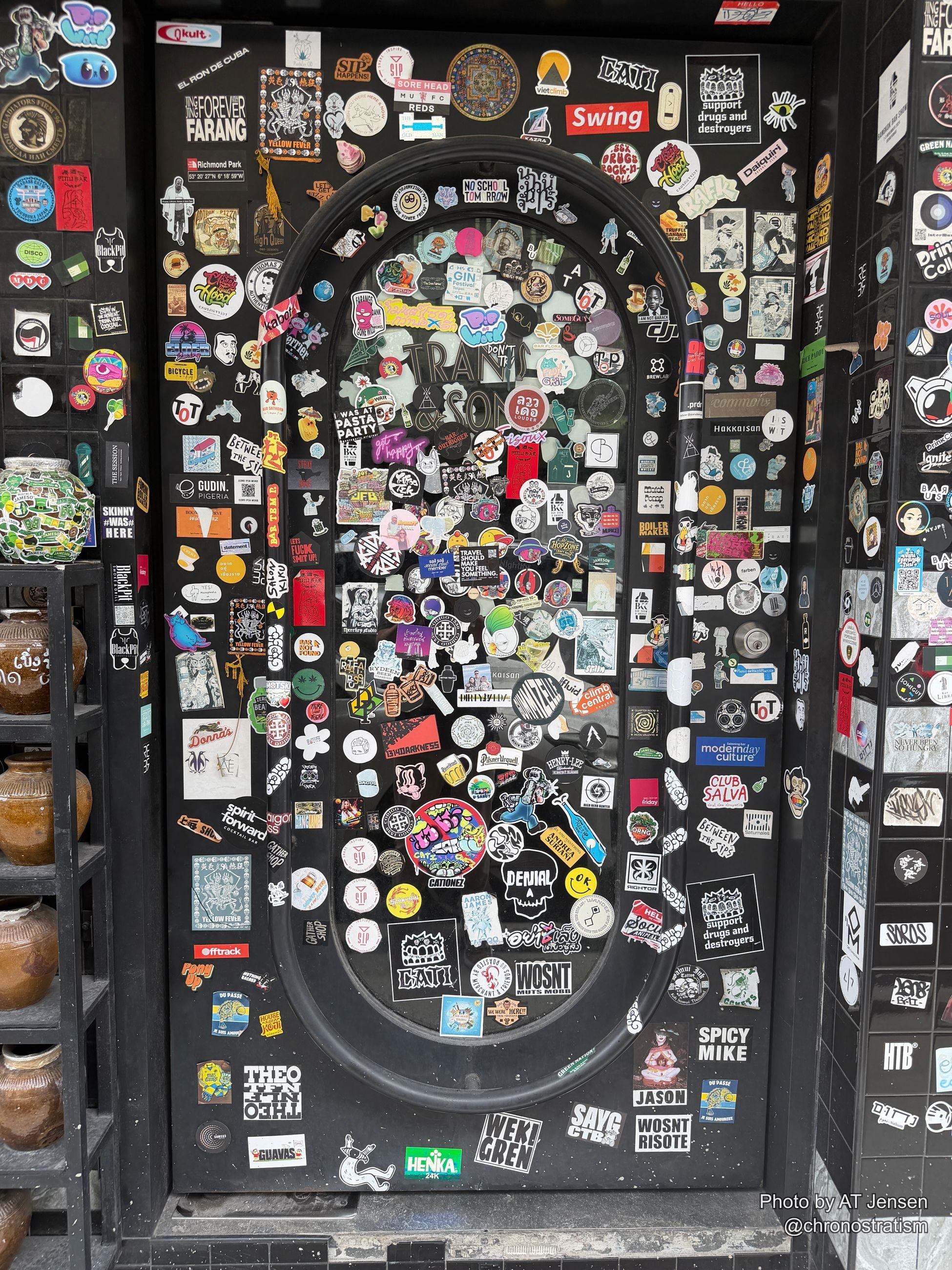 Hundreds of overlapping stickers armour a black counter surface edge to edge.