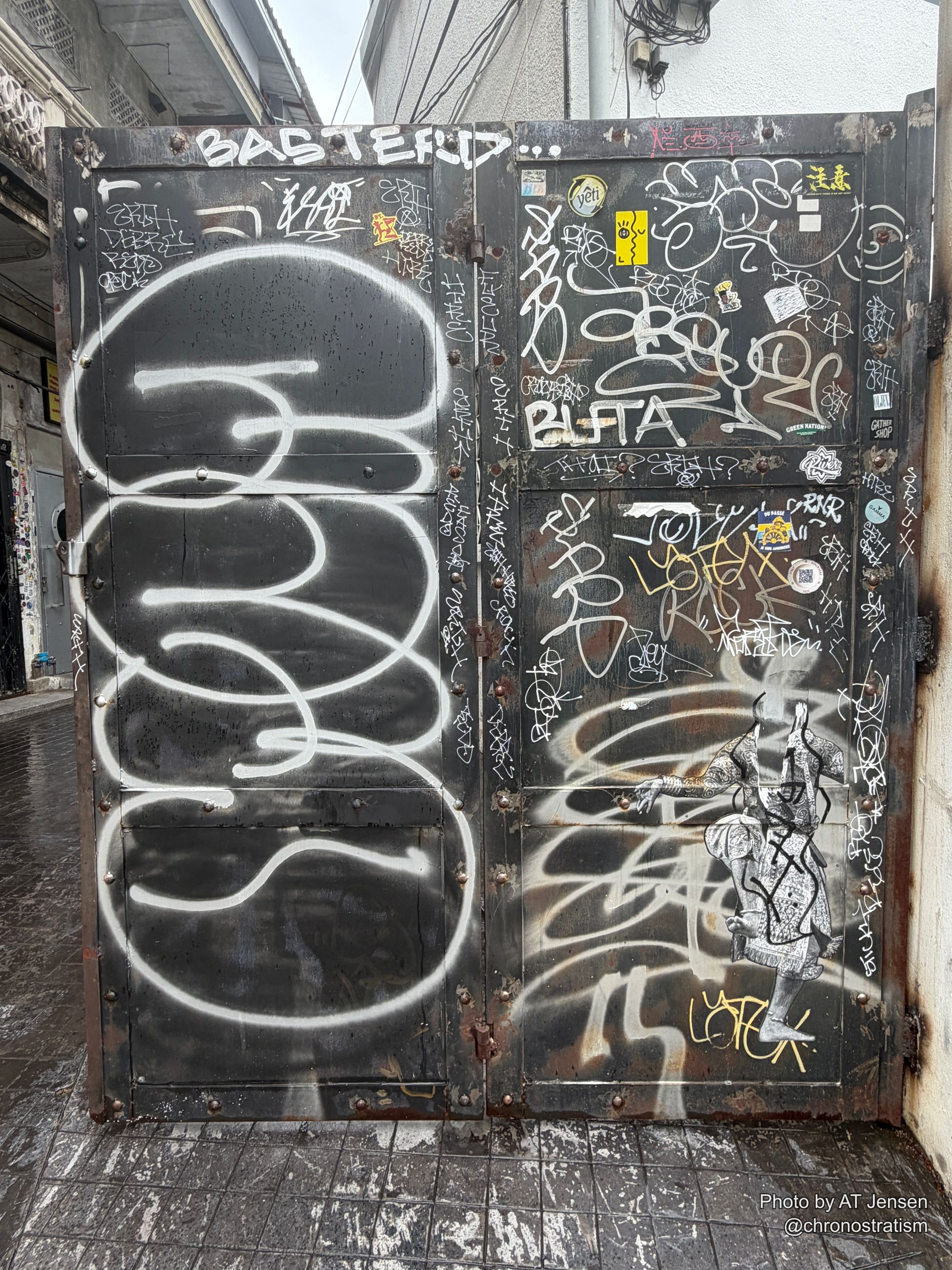 A dense sticker collage armours a black lacquered surface, hundreds of tags and logos overlapping.