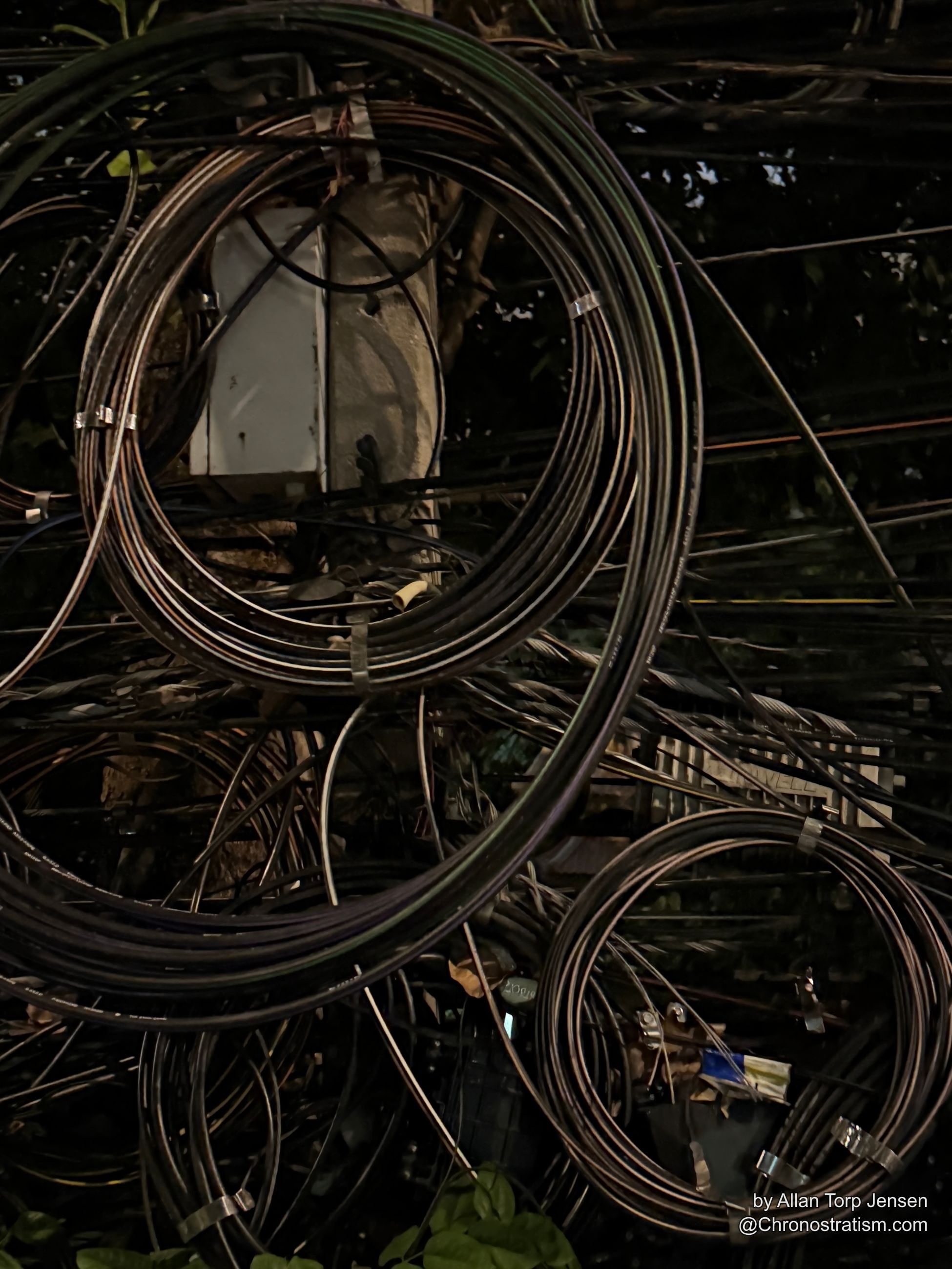 A final tangle of night wiring frames the stencilled junction box from below.