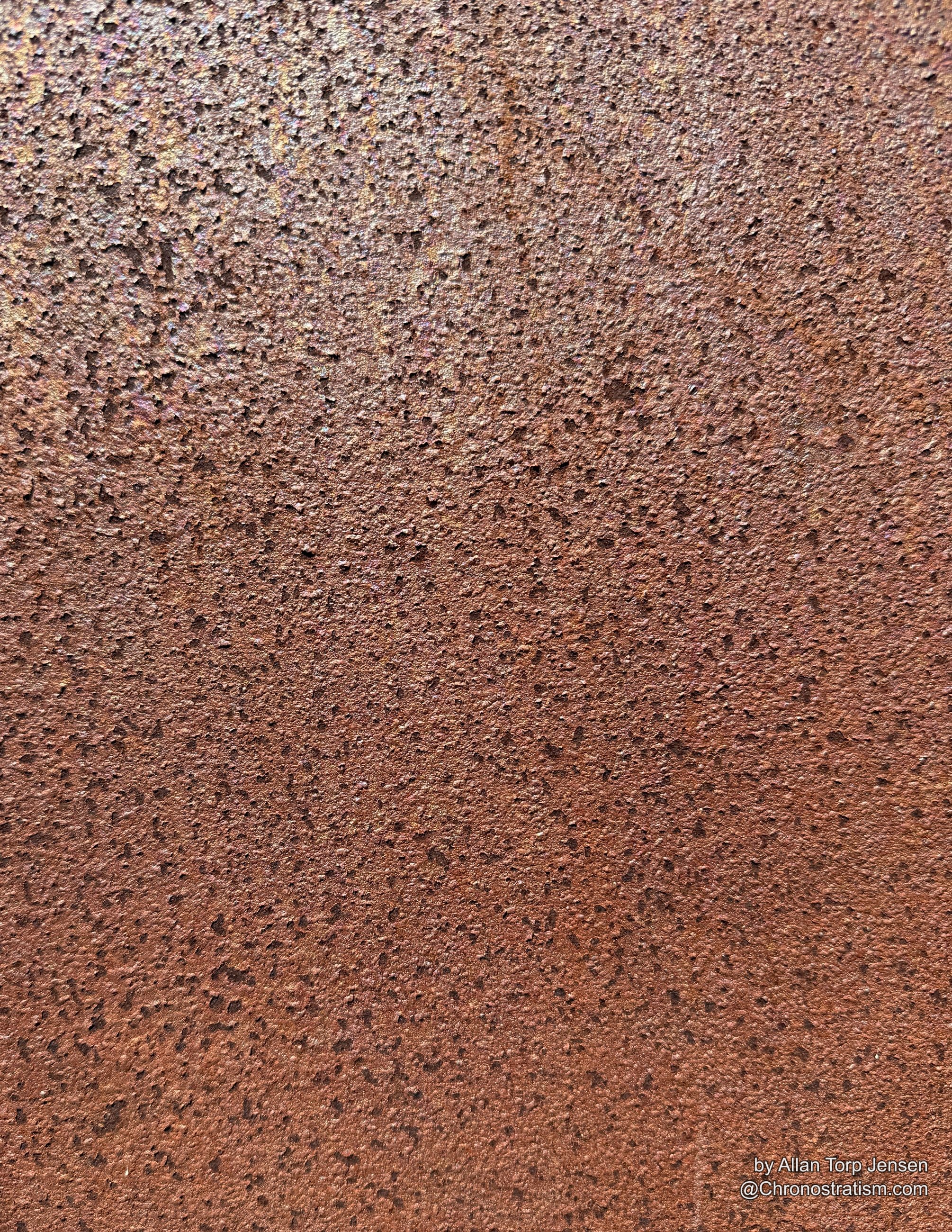 Fine-grained rust texture spreads uniformly across a weathered steel surface.