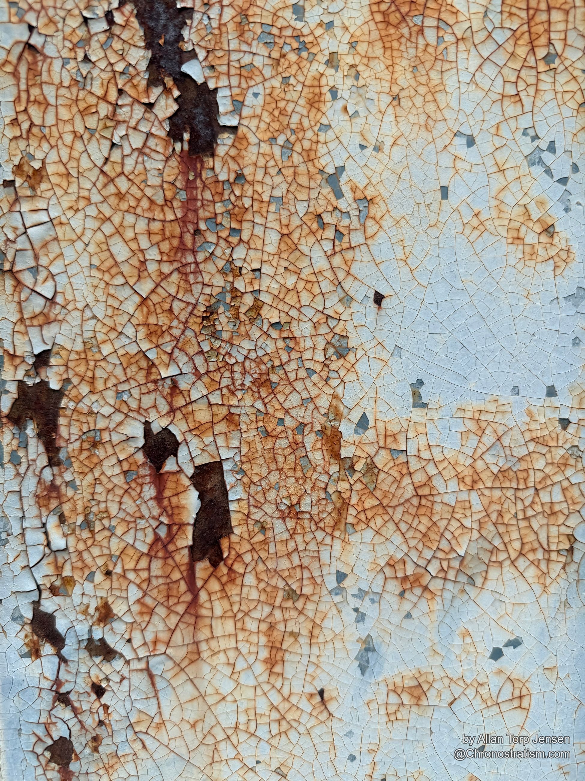 Dense micro-craquelure spreads across a cream panel, rust tracing faint horizontal seams beneath the surface.