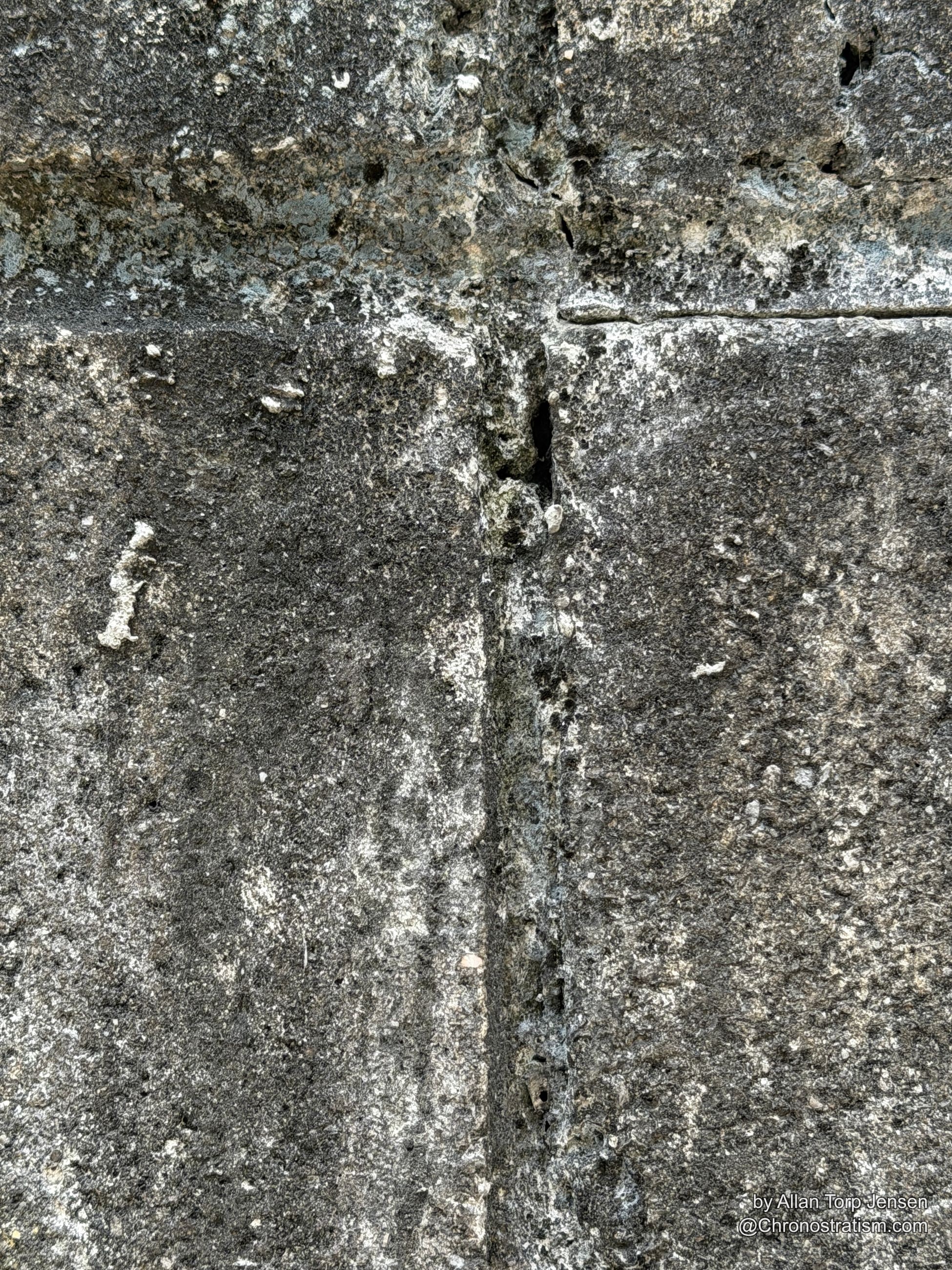 Plain weathered granite blockwork, mineral speckling and mortar joints in muted grey.