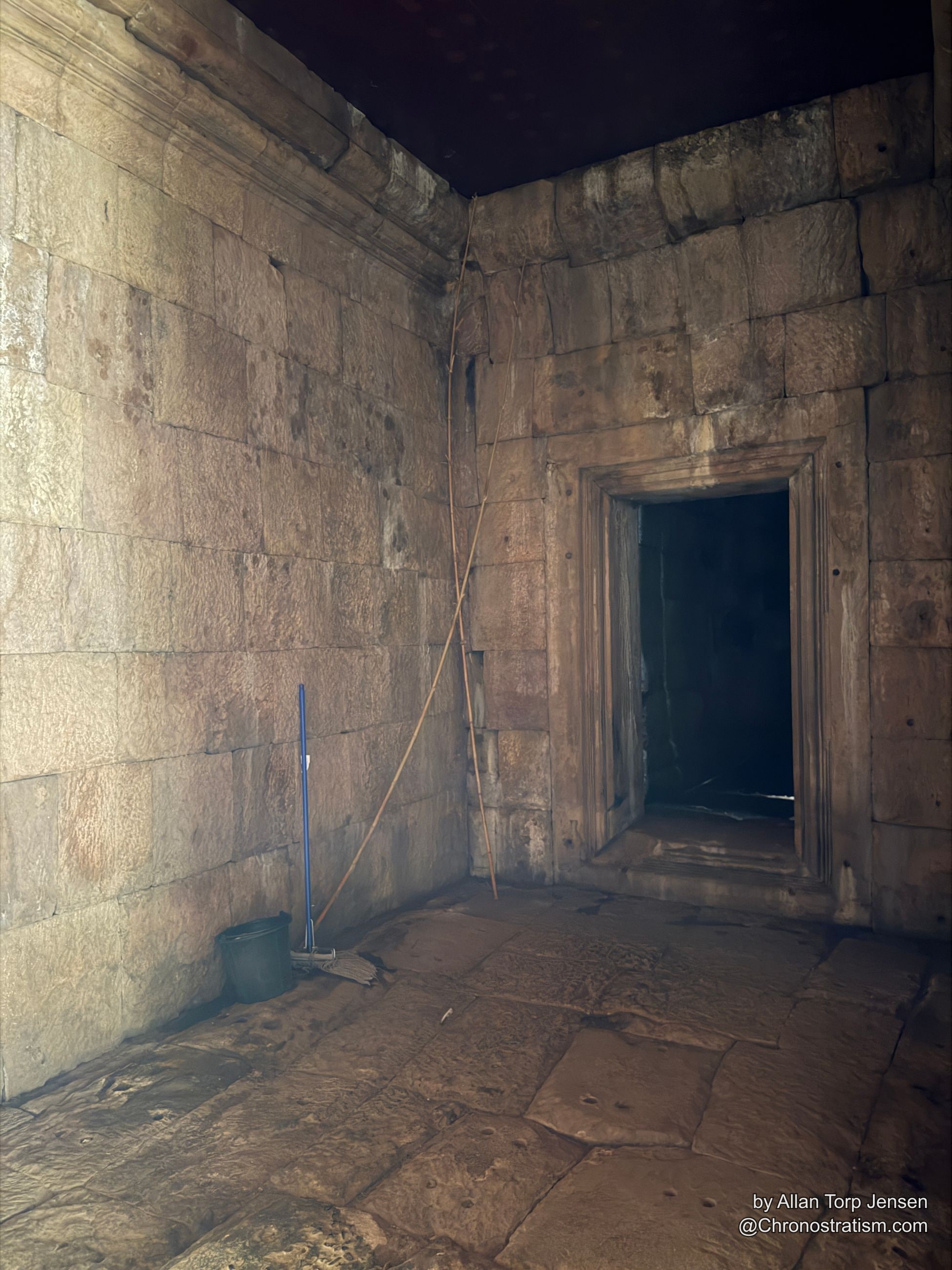 A sandstone temple chamber interior, sunlight falling through a carved window frame.