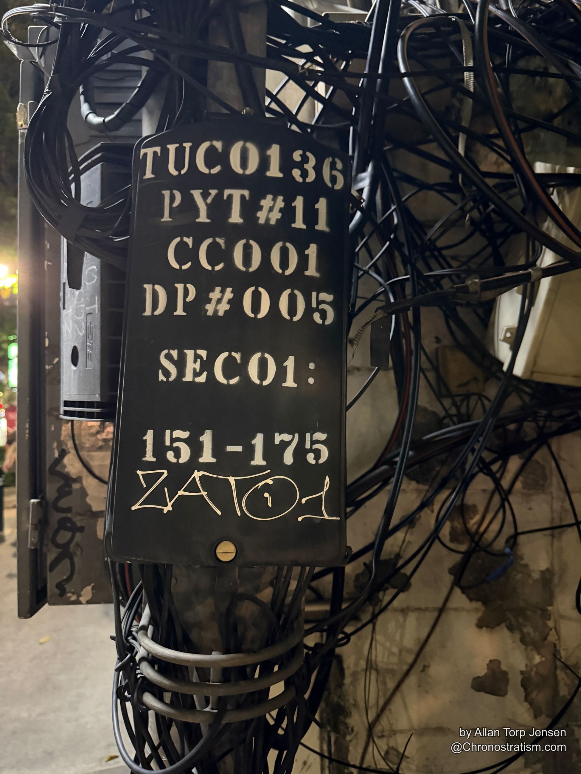 Stencilled codes TUC0136 and PYT#11 mark a daylight utility junction box tagged ZAQ.