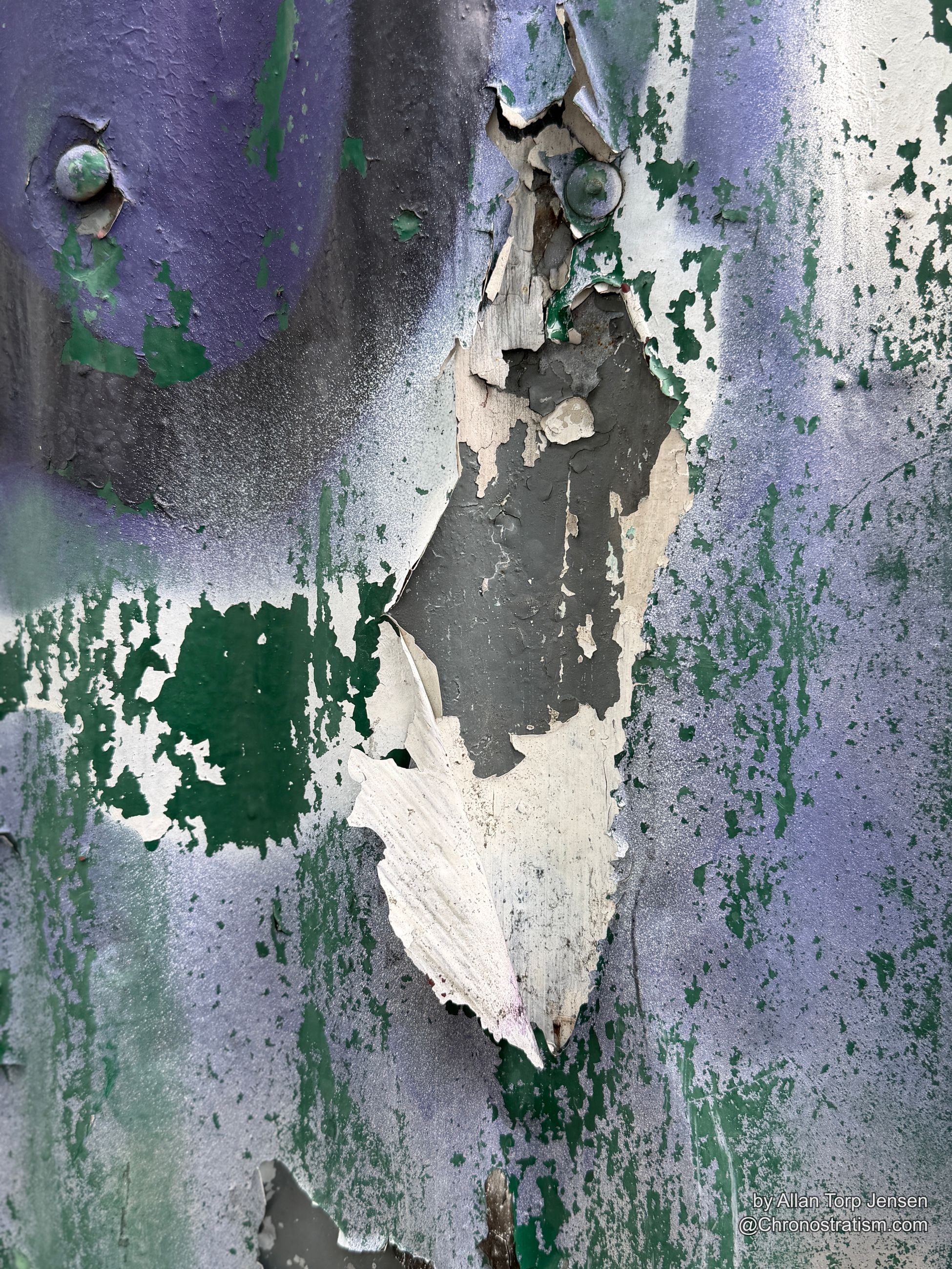 White paint pours and drips over the peeling layers below.